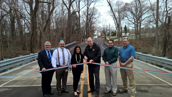 Curtis Shugars, Vincent Voltaggio, Heather Simmons, Robert Damminger, Ron Moore and Michael Sheahen celebrate the opening of the new Jessup Mill Road Bridge.