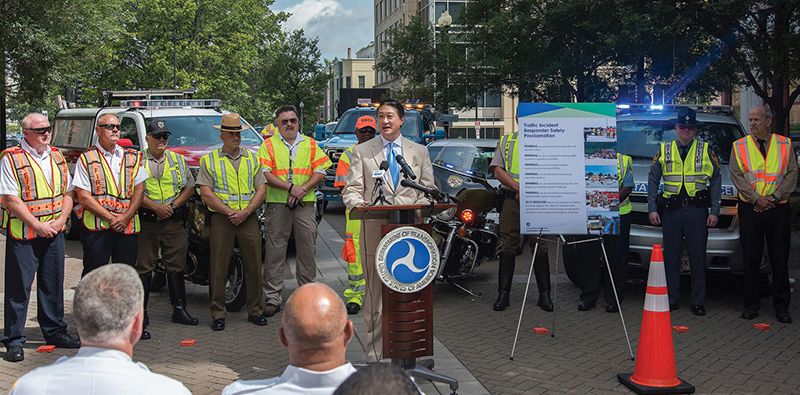 Federal Highway Deputy Administrator David Kim leads a ceremony marking the training of 200,000 first responders in traffic incident management.