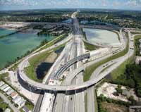 Photo. Overhead daytime view of a highway with an interchange crossing over it. Copyright, Smith Aerial Photos