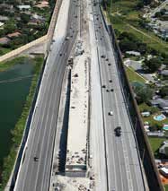 Photo. Overhead daytime view of traffic on an eight-lane highway.