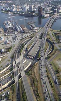 Photo. Overhead view traffic driving on a highway that crosses a river.
