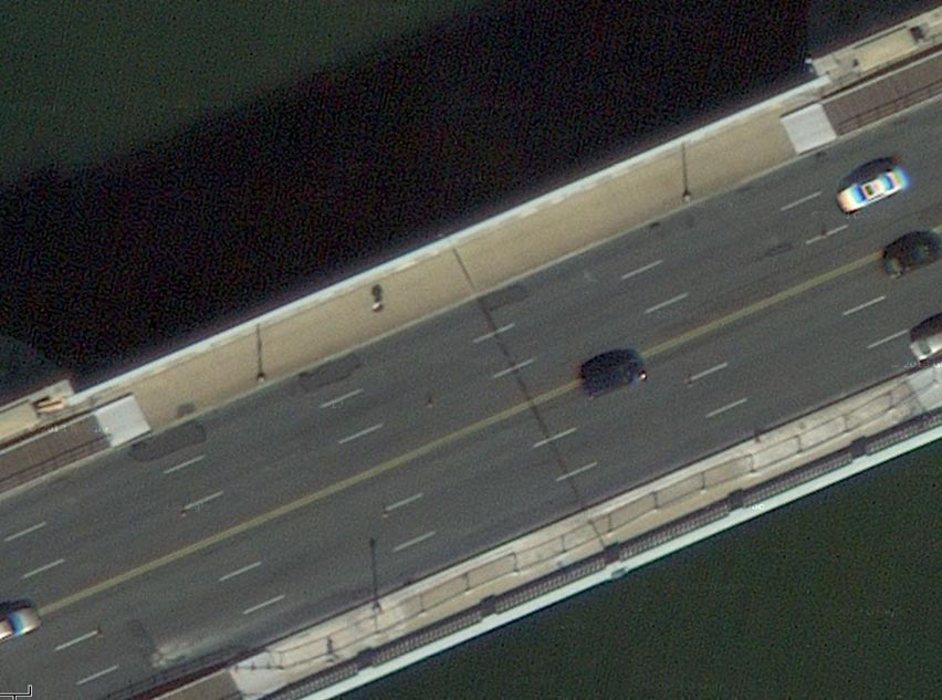 This slide shows an aerial view of the six-lane bridge deck of the Arlington Memorial Bridge. There are three lanes in each direction, and there are sidewalks visible on each side of the roadway. There are light posts on the sidewalk and vehicles on the bridge. Large asphalt patches of asphalt overlay are also visible. The slide number is visible in the lower right corner.