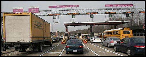 Picture 2. Graphic. The picture shows a large toll plaza with several lanes of cars feeding into the toll booths.