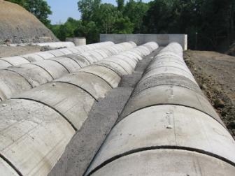 The flowable fill can be seen between the pipes.