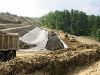 Water was periodically added to the mixture to maintain optimum compaction conditions.