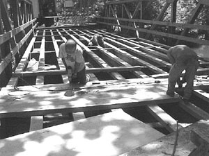 Photo of crew installing timber deck on a bridge.