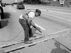 Photo of worker sealing a joint on a bridge
