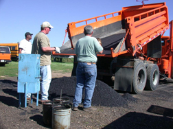 This photo shows the sampling and splitting of the asphalt mixture from Iowa's US 218 project for performance testing.