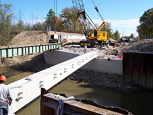 Concrete box beams are placed directly on the GRS abutments.