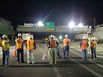 A nighttime photo of the installation of new Graves Avenue Bridge in Florida while the FDOT employees watched