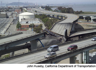 Figure 1. Photo. Damage to the I-880 and I-580 connector roads in San Francisco, CA. A portion of the I-30 eastbound to I-580 eastbound connector road has collapsed onto the connector road between westbound I-80 and southbound I-880.