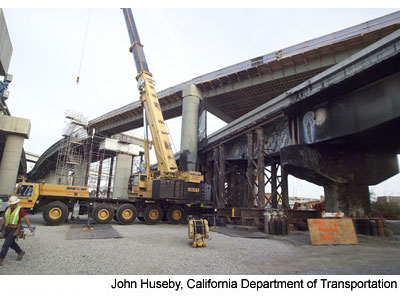 Figure 3. Photo. Girder installation on I-580. New steel girders are installed on the I-580 ramp. A crane is lifting a girder.