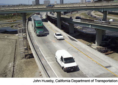 Figure 5. Photo. New I-880 ramp. Two cars and a truck travel across the new I-880 ramp on May 8, 2007.