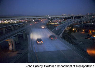 Figure 6. Photo. New I-580 ramp. Three cars drive across the new I-580 ramp in the evening hours of May 24, 2007.