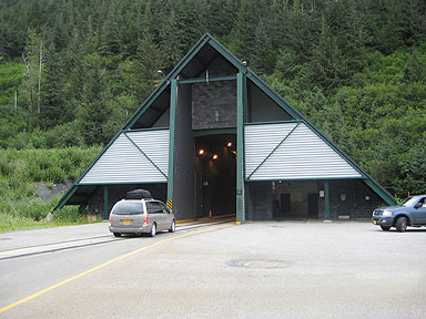 The entrance to Alaska's Anton Anderson Memorial Tunnel in Whittier. A minivan is entering the tunnel.