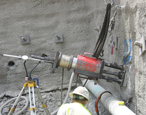 Figure 5. Photo. A worker performs load testing on a soil nail in Salt Lake City, Utah.