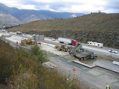 Figure 1. Photo. An aerial view of road construction equipment on I-15 in Devore, CA.
