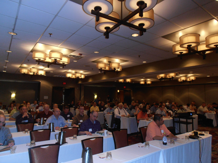 Participants sitting at tables at an FHWA Intelligent Compaction workshop held in Minneapolis, MN.