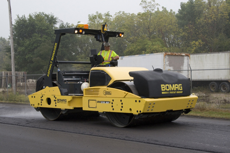 A front view of an operator driving an intelligent compaction paver as it is used to compact a thin lift of hot-mix asphalt on U.S. 52 in West Lafayette, IN.