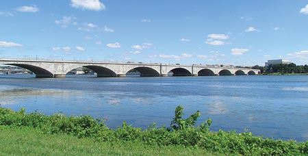 The image shows the Arlington Memorial Bridge spanning the Potomac River. The Lincoln Memorial is shown on the right side of the photograph. Eight of the nine arches of the Arlington Memorial Bridge are shown.