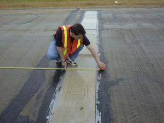 Researcher measuring pavement 