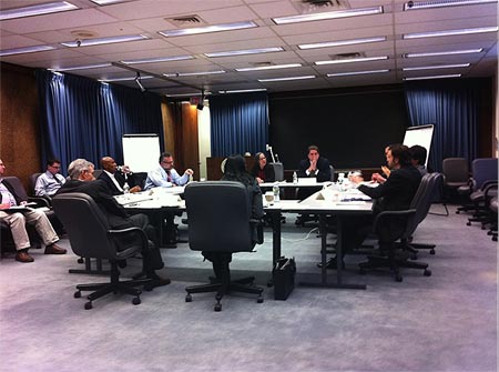 Photograph of a conference room with participants engaged in a meeting Photograph of a conference room with participants engaged in a meeting