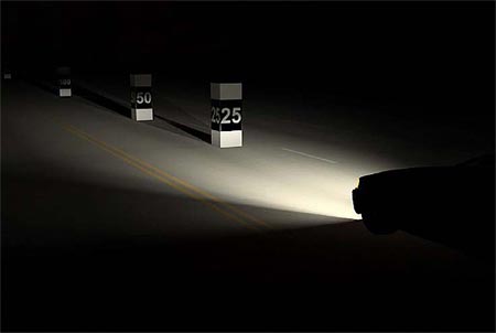 Photo of a car’s headlights shining on distance markers labeled 25 and 50 Photo of a car’s headlights shining on distance markers labeled 25 and 50