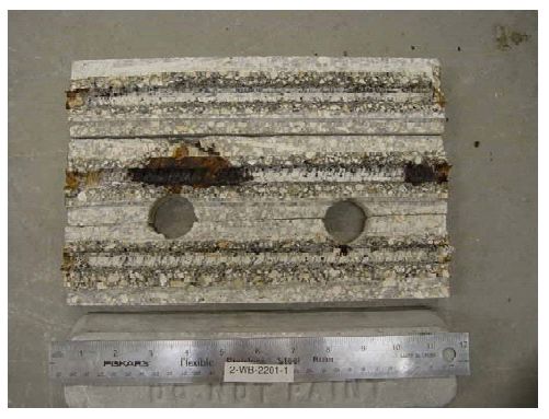 One bar trace exhibits extensive corrosion products along about 8 centimeters, and minor corrosion products are apparent at several of the trace ends.