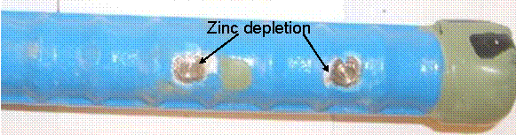 Regions where disbondment occurs on the multiple-coated (MC) bars show a ring of darkened metal around the damage site, indicating the zinc in this region has been consumed.