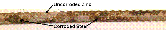Galvanized reinforcement shows heavy orange corrosion products over most of the bar surface with isolated regions of intact zinc present.