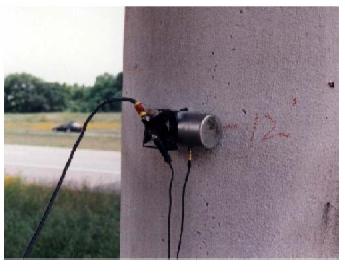 Horizontal accelerometer on side of column of west pier, Woodville Road Bridge. This image shows a horizontal seismic accelerometer installed on the side of a column of the west pier of the Woodville Road Bridge.