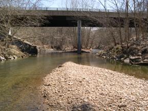 Figure 215. Middle Patuxent River, Piedmont-looking downstream at bridge. Photo. This is looking downstream at the two-span bridge. The midchannel gravel bar is upstream of the bridge. The flow is slightly misaligned toward the left abutment. 
