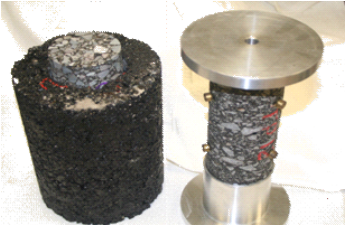 This photo shows a gyratory-compacted specimen with a 3-inch (76 mm)-diameter core taken from the center next to a core test specimen with top and bottom tension platens glued to each end.