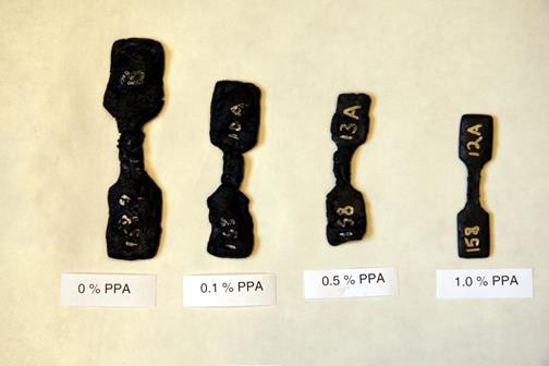 This photo  shows four mastic samples, cast as dog bones, made from 50 percent Citgo® asphalt  and 50 percent montmorillonite clay after water immersion for 105 days.  The asphalt binders used were modified with 0-, 0.15-, 0.5-, and 1-percent polyphosphoric  acid.