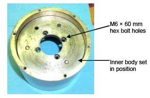 The photograph shows the inner body set into place and the position of the four M6 by 60 millimeters hex bolts.