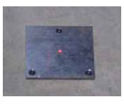 Figure 72. Photo. Laser dot centered on base plate. This figure shows a photograph of the laser dot from the laser sensor centered on the base plate.