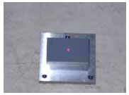 Figure 77. Photo. Block on top of base plate with calibration plate on top of block. This figure shows a photograph of the calibration block placed on top of the base plate with the calibration surface plate placed on top of the block.