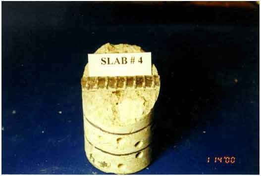 Figure 15. Photo. Autopsy of core extracted from slab 4 in December 1999. This photograph shows an autopsy of a core extracted from slab 4 in December 1999. No ongoing corrosion is visible in the photo of the extracted rebar.