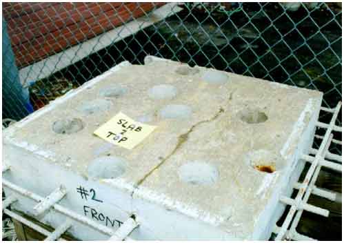 Figure 8. Photo. Corrosion on the ends of rebars exposed in core holes of slab 2. This photograph shows corrosion on the ends of the rebars visible in the core holes of slab 2.