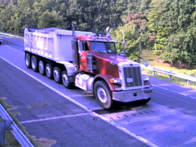 Figure 31. Photo. Seven-Axle Class 7 truck at the Maryland site. This photo shows a seven axle Class 7 truck observed at the Maryland site, consisting of a steering axle, and a tandem axle with four drop axles located in front of the tandem axle.