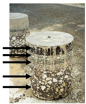 Figure 1. Photo. Core recovered from an LTPP test section used to equate laboratory-measured modulus values to backcalculated elastic modulus values (Texas SPS-5 section). This photo shows a core recovered from a Long-Term Pavement Performance (LTPP) Texas Specific Pavement Studies (SPS)-5 test section. Five arrows point to the individual asphalt concrete layers of the core.