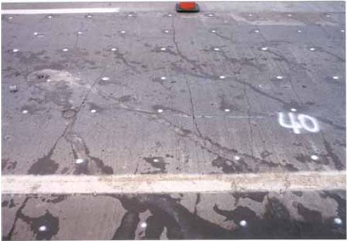 Photograph showing typical cracking associated with the southbound test section of U S 41 S F C. The section is silica fume-modified concrete. Significant cracking is shown throughout the area pictured.