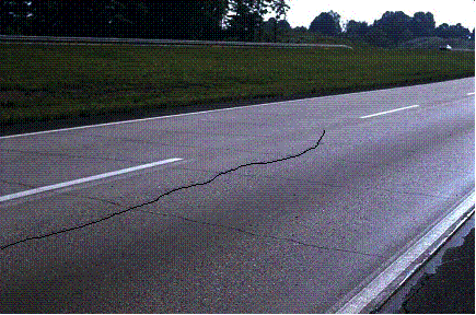 Figure 20.  Photo.  Longitudinal crack in CRCP due to thermal shock.  Crack is enhanced for clarity.  Photo depicts many transverse crack as well an enhancement of a longitudinal crack in CRCP due to thermal shock, which is the object of interest.