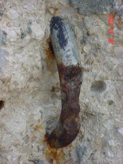 Figure 25. Corrosion of an exposed reinforcing bar. Photo. Example of severe localized corrosion on an exposed stainless steel reinforcing bar on the Progresso pier.