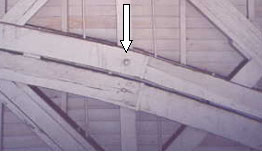 The picture shows the diagonal supports in the background with the arch superimposed and connected to the vertical post.