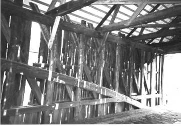 This picture shows the interior of the Burr arch bridge at the window and near the entrance to the bridge with the various structural elements.