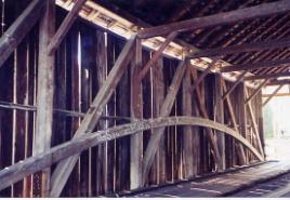 This interior shot of a single, lighter weight Burr arch attached only to the inside of the truss is suspect in terms of support.