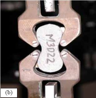 Photos. AASHTO T132 setup including (a) test grips and (b) specimen. (a) shows the AASHTO T132 test grips without a specimen. (b) shows a closeup of the specimen in the grips during a test.