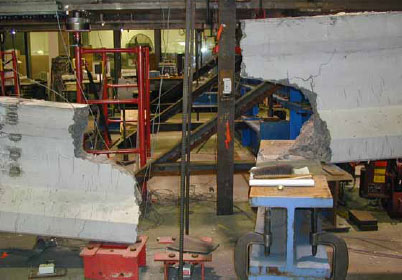 Figure 18. Photo. Girder 80F immediately after failure. This photo shows the failure location for this girder. The girder severed into two pieces at the west load point.
