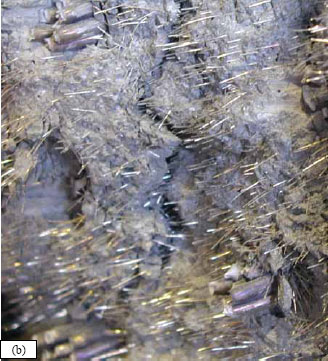 Figure 19. Photo. Failure surface of Girder 80F including (b) closeup of west failure surface showing pulled-out fibers and necked strands. These two photos show the full west failure surface and a closeup of the west failure surface. The closeup shows that the fibers pulled out of the corresponding failure surface and that the strands necked and ruptured.